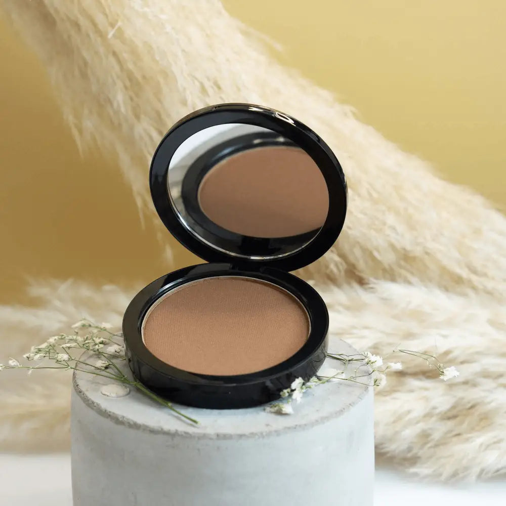 MIANIMED Premium skincare compact powder open with warm brown shade and logo on the lid.
