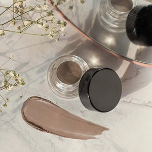 MIANIMED Premium skincare product on a marble surface with flowers and a mirror.